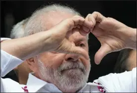  ?? ANDRE PENNER — ASSOCIATED PRESS FILE ?? Brazilian President Luiz Inacio Lula da Silva flashes a heart-hand sign at supporters during a rally in Sao Paulo, Brazil, on May 1. Lula likes to boast he had a good first year returning to the job.