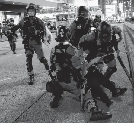  ?? REUTERS ?? Riot police detain an anti-government protester during a protest at Mong Kok, in Hong Kong, China on Sunday.