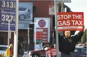  ?? Paul Chinn / The Chronicle ?? Anthony Ballester and others protest California’s 12-cent gas tax increase in San Francisco on Nov. 4. The tax is intended to help the state repair roads.