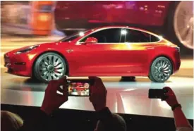  ??  ?? CALIFORNIA: In this file photo, Tesla Motors unveils the new lower-priced Model 3 sedan at the Tesla Motors design studio in Hawthorne, California.—AP