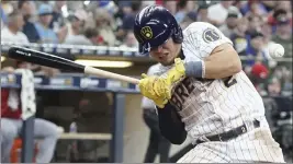  ?? MORRY GASH — THE ASSOCIATED PRESS ?? Milwaukee's Luis Uria grimaces as he is hit by a Cincinnati pitch Sunday. Also wince worthy is the fact the Brewers have won just one of six games since trading closer Josh Hader.