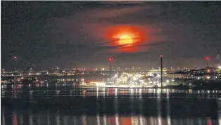  ??  ?? A warm night sets in as the moon comes up! Lew Turner captured the glow in the sky over the Bedford Basin in Halifax, N.S.