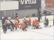  ?? MEDIANEWS GROUP PHOTO ?? The Flyers get back to work with a morning workout at the Skate Zone in Voorhees Monday. Social distancing isn’t entirely possible during such activities, but hey, at least they have face shields.