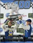  ?? NICK WASS — THE ASSOCIATED PRESS ?? Chase Elliott, left, poses with the trophy in Victory Lane after winning a NASCAR Cup Series auto race, Sunday at Dover Internatio­nal Speedway in Dover, Del.