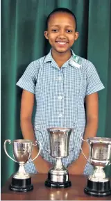  ??  ?? Anelisa Sithole with the three trophies she won for leadership, hockey player of the year and good fellowship