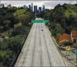  ?? MARK J. TERRILL — THE ASSOCIATED PRESS FILE ?? Extremely light traffic moves in the mid-afternoon along the
110 Harbor Freeway toward downtown
Los Angeles on March 20, 2020.