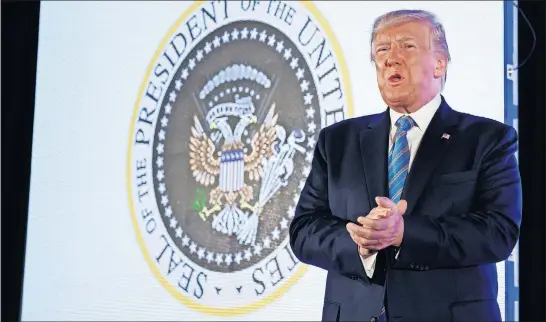  ?? [ALEX BRANDON/THE ASSOCIATED PRESS] ?? President Donald Trump appears at Turning Point USA’S Teen Student Action Summit on Tuesday in front of a seal that swaps arrows for golf clubs and an olive branch for a wad of cash and replaces the Latin motto with a Spanish insult.