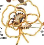  ?? ?? This Van Cleef & Arpels gold flower brooch with brilliant diamond and blue sapphire details was one of Betty’s favorites. It’s likely to sell for more than $14,000.