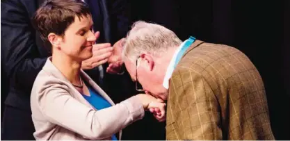  ??  ?? COLOGNE: Alexander Gauland, center, kisses the hand of the head of Germany’s right-wing populist Alternativ­e for Germany (AfD) party, Frauke Petry during the party congress at the Maritim Hotel in Cologne, western Germany, yesterday. — AFP