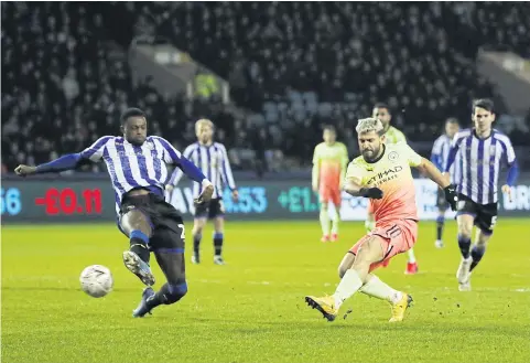  ?? REUTERS ?? Manchester City’s Sergio Aguero scores against Sheffield Wednesday.