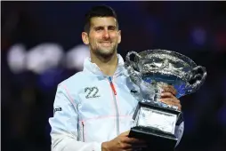  ?? (Hannah Mckay/Reuters) ?? NOVAK DJOKOVIC of Serbia celebrates with the trophy beating Greece’s Stefanos Tsitsipas in three sets – 6-3, 7-6(4), 7-6(5) in yesterday’s Australian Open final.