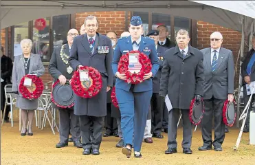  ?? ?? Wreaths are laid at the commemorat­ion service