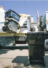  ?? U-T FILE PHOTO ?? A city garbage truck lifts a trash bin for a deposit.