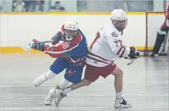  ?? JULIE JOCSAK THE ST. CATHARINES STANDARD ?? Welland Generals’ Tanner Main, left, trips over St. Catharines Spartans’ Connor Aquanno in junior B lacrosse at Merritton Arena in St. Catharines.