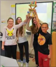  ?? PHOTO COURTESY OF SPRING-FORD AREA SCHOOL DISTRICT ?? Spring-Ford Area Middle School students Kieran Treece, Tory Seeley, Kaleigh Tomichek and Lucy Stone hold their trophy after winning the fourth annual Maglev Train Competitio­n against North Wales Elementary School.