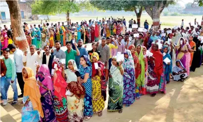  ?? PTI ?? People line up at a polling station in Mirzapur during the seventh and final phase of voting in Uttar Pradesh on Wednesday. —