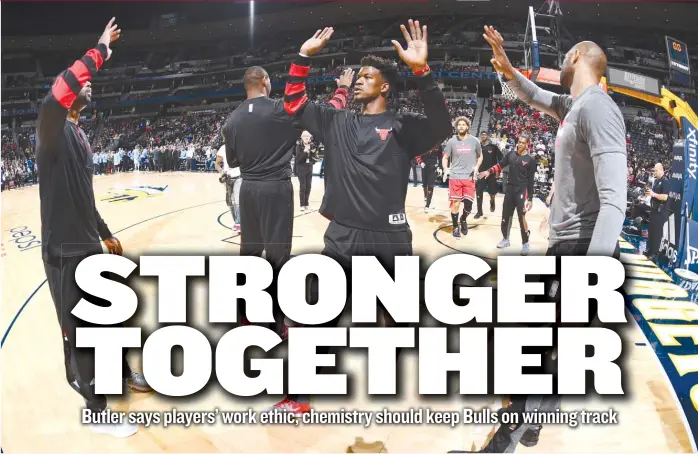  ?? | GARRETT ELLWOOD/ GETTY IMAGES ?? Jimmy Butler ( center) doesn’t see any reason he and his teammates can’t work on their games constantly. ‘‘ I think of it like this: I don’t see what else you have to do all day,’’ he said.