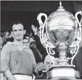  ??  ?? A proud Tom Neville accepts the Bob O’Keeffe Cup as Wexford captain after Wexford defeated Kilkenny in the Leinster hurling final of 1965.