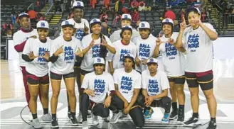  ?? KEVIN RICHARDSON/BALTIMORE SUN PHOTOS ?? Shaw women’s basketball players and coaches pose for a photo after defeating Winston-Salem State, 54-48, on Thursday to advance to the semifinals of the CIAA Tournament at CFG Bank Arena.