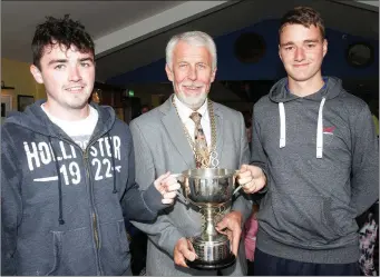  ??  ?? Cllr. Jim Moore presenting Bill Crowdle and Gary Murphy with the trophy for most wins for the New Ross Parks camp.