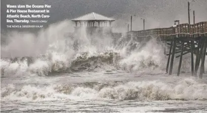  ?? TRAVIS LONG/ THE NEWS & OBSERVER VIA AP ?? Waves slam the Oceana Pier &amp; Pier House Restaurant in Atlantic Beach, North Carolina, Thursday.