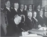  ??  ?? Calvin Coolidge signs 1928’s ban on war.