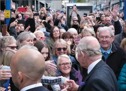  ?? ?? King Charles greets well-wishes after arriving in Dunfermlin­e. Photo: Jim Payne