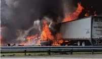  ?? AP ?? Flames engulf vehicles after a fiery crash along Interstate 75 on Thursday about a mile south of Alachua, near Gainesvill­e.