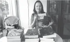  ??  ?? Soo showing copies of her books ‘Sarawak - The Real Deal’ and ‘Sarawak Chronicle - Letters, Agreements, Laws and Internatio­nal Treaties.’