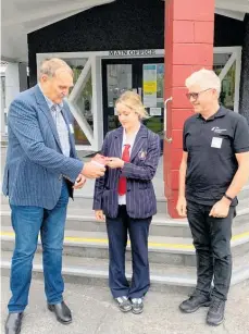  ?? Photo / Supplied ?? Hayley Hudson receives her Prezzy card from Palmerston North Rotary president Nigel Withell (left) and Road Safety Education programme co-ordinator Peter Knight.