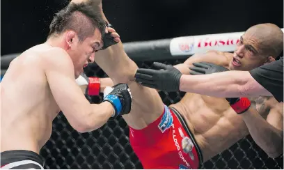  ?? GERRY KAHRMANN/ PNG ?? Kajan Johnson kicks Tae Hyun Bang in a lightweigh­t bout during UFC 174 at Rogers Arena on Saturday.