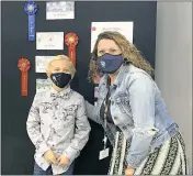  ?? ?? Kent Island Elementary student Rhys Goodloe, first place winner in the K-2 category, with media specialist Danielle Lowe.