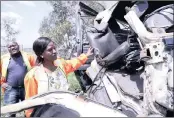  ??  ?? Glen Xaba, KZN Transport acting head, and the department’s spokesman, Kwanele Ncalane, left, view the wreckage of the vehicles involved in the accident that claimed the lives of eight people and injured scores of other passengers.