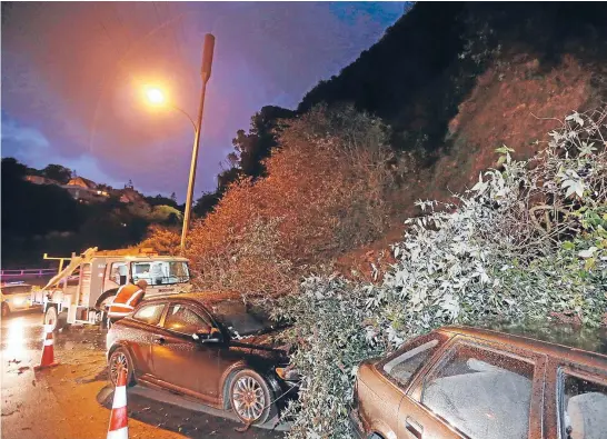 ?? Photo: CAMERON BURNELL/FAIRFAX NZ ?? Cars were covered in debris on Birdwood St, Karori, after a slip.