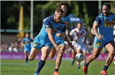  ??  ?? Titans halfback Kane Elgey looks to get on a loose ball in yesterday’s loss to the Dragons.