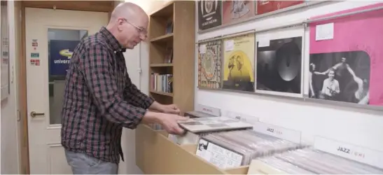  ?? DANIELLE BEVERLY ?? Chicago record store owner Rick Wojcik looks over a vinyl collection in the documentar­y “Dusty Groove.”