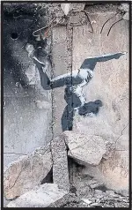  ?? ?? Banksy’s mural of a gymnast on a ruined building in war-torn Borodyanka, above, and judo fighter floors Putin, right