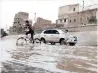 ??  ?? A BOY rides a bike along a flooded street after heavy rains in the old quarter of Sanaa, Yemen, yesterday.