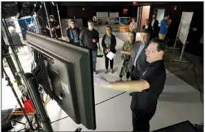  ?? NWA Democrat-Gazette/ANDY SHUPE ?? Kris Katrosh (right), media production manager for the University of Arkansas Global Campus, leads a tour April 26 of the studio space inside the campus’ newly renovated building in Fayettevil­le. Improvemen­ts to the building, including a new black box...