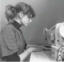  ??  ?? Claire Wilson sews a mask.