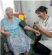  ?? PHOTO: DAVID UNWIN/STUFF ?? Radius Peppertree rest home resident Gwen Pawson has her blood pressure checked by nurse Nikki Fox. Will there be enough carers in the sector after 2020?