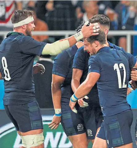  ?? Images. Picture: Getty ?? George Horne, centre, is congratula­ted by team-mates after completing his hattrick in the thrashing of Russia.