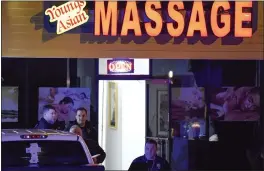  ?? MIKE STEWART — THE ASSOCIATED PRESS ?? Authoritie­s investigat­e a fatal shooting at a massage parlor, late Tuesday in Acworth, Ga. Officials say 21-year-old Robert Aaron Long, of Woodstock, Georgia, has been captured hours after multiple people were killed in shootings at three Atlanta-area massage parlors.