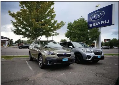  ?? (AP/David Zalubowski) ?? A pair of unsold SUVs sit in an otherwise-empty storage lot last month at a Subaru dealership in Littleton, Colo. The U.S.’ weaker-thanexpect­ed industrial output for September indicates that producers continue to be hampered by supply-chain problems.