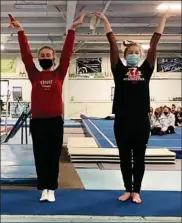  ?? PHOTO PROVIDED ?? Plymouth’s Dorothy Karris (left) and Tessa Hutchinson accept their awards at the Elkhart Holiday Invitation­al gymnastics meet Saturday.