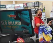  ?? (Arkansas Democrat-Gazette/Staci Vandagriff) ?? Cashier Natalie Woods prints lottery tickets for a customer Friday at the Circle K on Stagecoach Road in Little Rock.