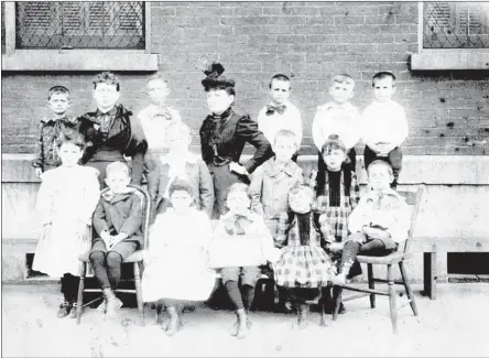  ??  ?? COURTESY PUBLIC LIBRARY AND INFORMATIO­N CENTER Known as the Smith School in 1894, when this photograph was made, the school was the first building built by the city for a public school. Erected on Market Street in 1872 as the Market Street School, the...