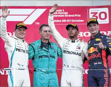  ??  ?? Mercedes’ British driver Lewis Hamilton (2nd R) celebrates his victory with second-placed Mercedes’ Finnish driver Valtteri Bottas (L) and third-placed Red Bull racing’s Dutch driver Max Verstappen (R) after the Formula One Japanese Grand Prix at Suzuka on Sunday