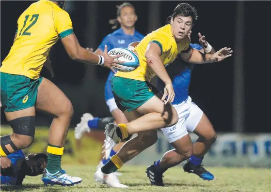  ??  ?? Gold Coaster Dylan Riley offloads in the Australian under-20 team’s clash with Samoa. Picture: SPORTOGRAP­HY