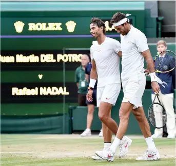  ??  ?? Spain’s Rafael Nadal (left) embraces Argentina’s Juan Martin del Potro after winning the men’s singles quarter-finals match of the 2018 Wimbledon Championsh­ips at The All England Lawn Tennis Club. — AFP
